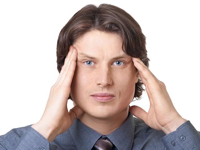 man-touching-brow
