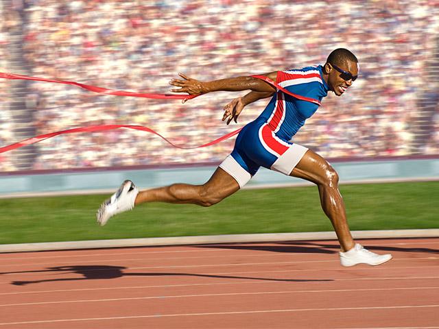 man crossing the finish line