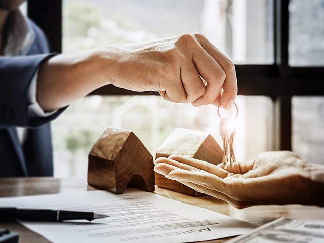 house keys being placed in hand of new owner
